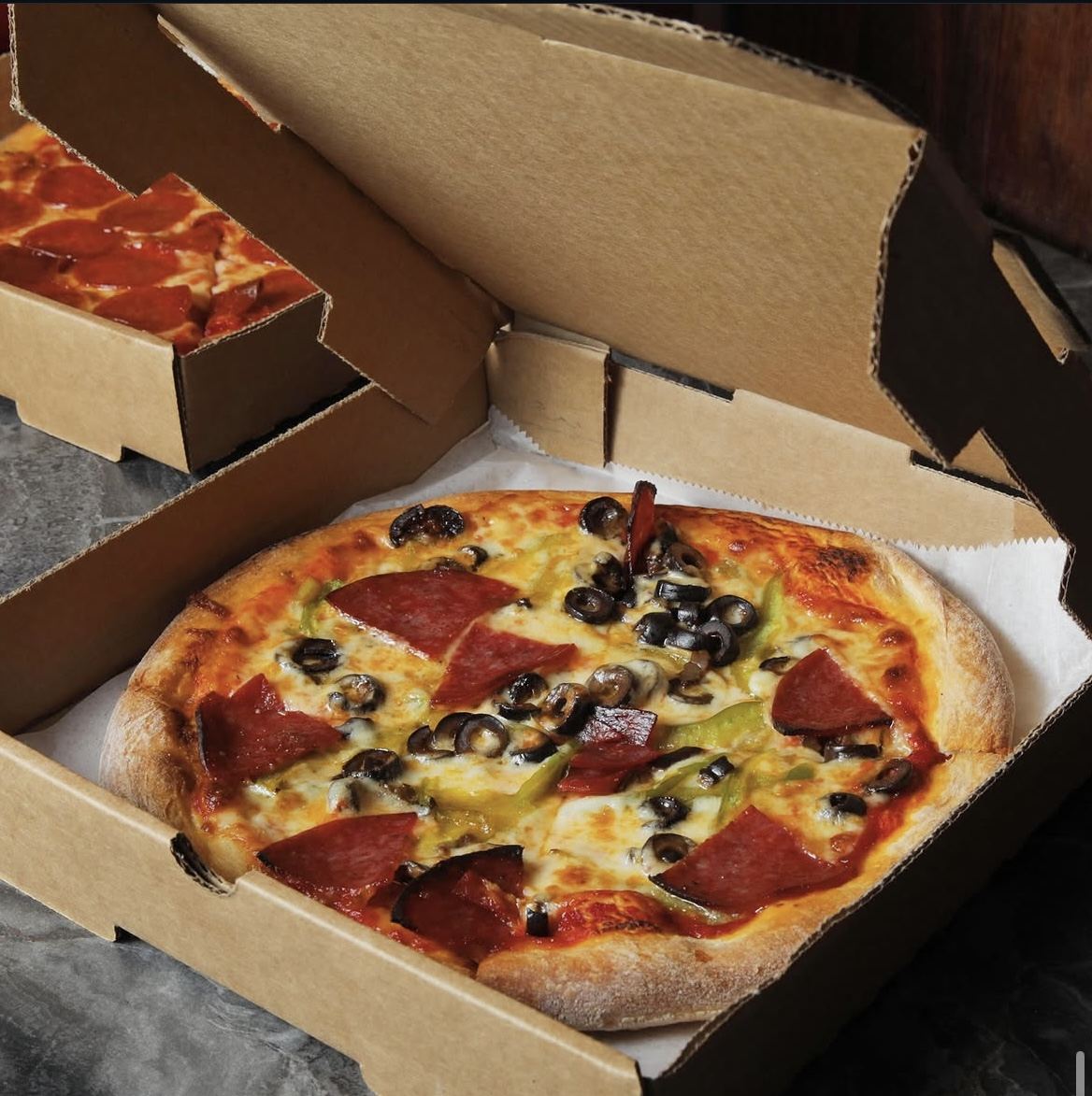 Supreme pizza with pepperoni, olives, and peppers